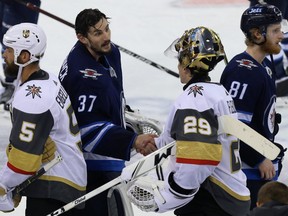 Winnipeg Jets goaltender Connor Hellebuyck (37) congratulates Vegas Golden Knights goaltender Marc-Andre Fleury after Vega won the Western Conference final in Winnipeg on Sun., May 20, 2018. Kevin King/Winnipeg Sun/Postmedia Network