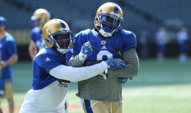 Defensive back Chris Randle (right) is angled off by Kevin Fogg during a tackling drill at Winnipeg Blue Bombers training camp at Investors Group Field in Winnipeg on Wed., May 23, 2018. Kevin King/Winnipeg Sun/Postmedia Network