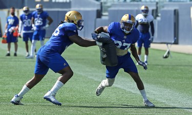 Defensive back Brandon Alexander (right) fights through a block during a special teams drill at Winnipeg Blue Bombers training camp at Investors Group Field in Winnipeg on Wed., May 23, 2018. Kevin King/Winnipeg Sun/Postmedia Network