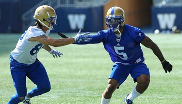 Defensive back Brian Walker (right) fights off the block of receiver Tylor Henry during Winnipeg Blue Bombers training camp at Investors Group Field in Winnipeg on Wed., May 23, 2018. Kevin King/Winnipeg Sun/Postmedia Network