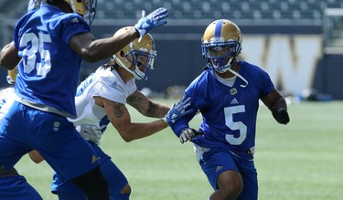 Defensive back Brian Walker (right) fights off the block of receiver Tylor Henry during Winnipeg Blue Bombers training camp at Investors Group Field in Winnipeg on Wed., May 23, 2018. Kevin King/Winnipeg Sun/Postmedia Network