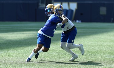 Defensive back Brian Walker (left) fights through the hold of receiver Myles White during Winnipeg Blue Bombers training camp at Investors Group Field in Winnipeg on Wed., May 23, 2018. Kevin King/Winnipeg Sun/Postmedia Network