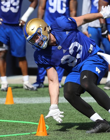 Defensive lineman Craig Roh scoops up a cone during a drill at Winnipeg Blue Bombers training camp at Investors Group Field in Winnipeg on Wed., May 23, 2018. Kevin King/Winnipeg Sun/Postmedia Network