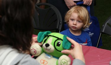 Benjamin Landygo, 2 1/2, watches as Scout has glasses fitted during the 32nd annual Teddy Bears' Picnic, in support of the Children's Hospital Foundation of Manitoba, at Assiniboine Park in Winnipeg on Sun., May 27, 2018. Kevin King/Winnipeg Sun/Postmedia Network