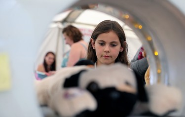 Brooklyn Henderson, 8, watches as Ruff gets an MRI during the 32nd annual Teddy Bears' Picnic, in support of the Children's Hospital Foundation of Manitoba, at Assiniboine Park in Winnipeg on Sun., May 27, 2018. Kevin King/Winnipeg Sun/Postmedia Network