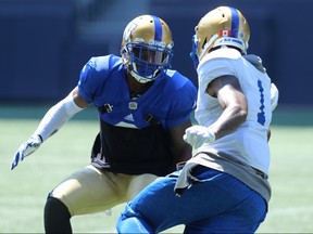 Chris Randle (left) covers Darvin Adams during Winnipeg Blue Bombers training camp on Sunday.