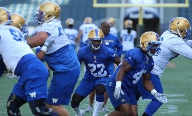 Chandler Fenner (centre) defends against the run during Winnipeg Blue Bombers training camp at Investors Group Field in Winnipeg on Mon., May 28, 2018. Kevin King/Winnipeg Sun/Postmedia Network