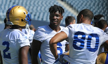 Corey Washington (centre) chats with fellow receivers Kenbrell Washington (left) and Rueben Randle during Winnipeg Blue Bombers training camp at Investors Group Field in Winnipeg on Mon., May 28, 2018. Kevin King/Winnipeg Sun/Postmedia Network