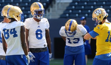 Corey Washington (6) has a chuckle in the huddle during Winnipeg Blue Bombers training camp at Investors Group Field in Winnipeg on Mon., May 28, 2018. Kevin King/Winnipeg Sun/Postmedia Network