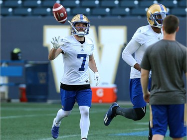 Weston Dressler flips the ball on his way back to the huddle during Winnipeg Blue Bombers training camp at Investors Group Field in Winnipeg on Mon., May 28, 2018. Kevin King/Winnipeg Sun/Postmedia Network