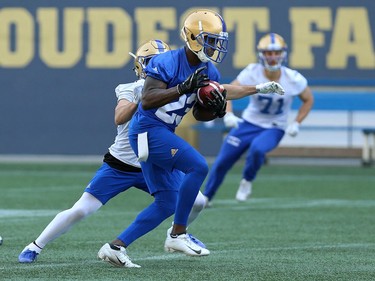 Anthony Gaither (right) jumps in front of Weston Dressler for an interception during Winnipeg Blue Bombers training camp at Investors Group Field in Winnipeg on Mon., May 28, 2018. Kevin King/Winnipeg Sun/Postmedia Network
