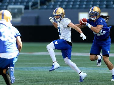 A pass well behind Weston Dressler (centre) is broken up by Jacob Firlotte during Winnipeg Blue Bombers training camp at Investors Group Field in Winnipeg on Mon., May 28, 2018. Kevin King/Winnipeg Sun/Postmedia Network