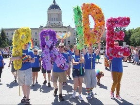 Participants carry a pride banner during the Gay Pride parade in Winnipeg, Man. Sunday June 05, 2016. Brian Donogh/Winnipeg Sun/Postmedia Network