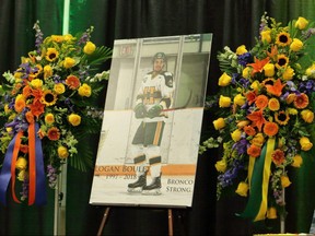 A photo and flowers are seen during a funeral service for Humboldt Broncos' Logan Boulet at the Nicholas Sheran Arena in Lethbridge, Alta. on Saturday, April 14, 2018. THE CANADIAN PRESS/David Rossiter ORG XMIT: DXR103