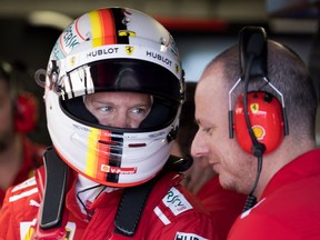 Ferrari driver Sebastian Vettel of Germany speaks with a teammate before leaving the pits at the Canadian Grand Prix in Montreal on Saturday, June 9, 2018.