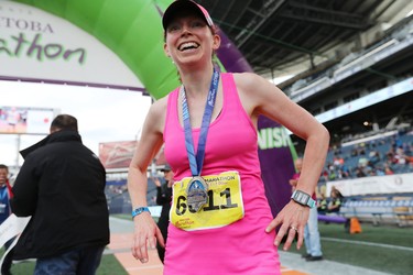 Darolyn Walker of Winnipeg catches her breath after winning the women's half marathon at the 40th annual Manitoba Marathon in Winnipeg, Man., on Sunday, June 17, 2018. Walker won the 13.1 mile race in a time of 1:25:17.3. (Brook Jones/Postmedia Network)