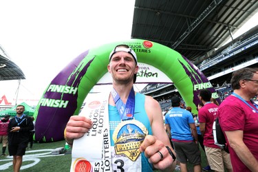Corey Gallagher shows off his finisher medal after winning the men's full marathon at the 40th annual Manitoba Marathon in Winnipeg, Man., on Sunday, June 17, 2018. Gallagher crossed the finish line in the 26.2 mile race in a time of 2:37:47.6. (Brook Jones/Postmedia Network)