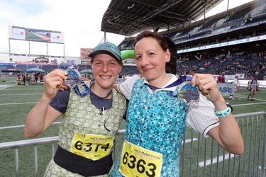 Mary Waldner of Wawanesa and Tracey Hofer of Westbourne, Man., show off their finisher medal after competing in the women's half marathon at the 40th annual Manitoba Marathon in Winnipeg, Man., on Sunday, June 17, 2018. (Brook Jones/Postmedia Network)
