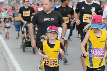 Maisie Manning of Winnipeg is all smiles as she competes in the super run at the 40th annual Manitoba Marathon in Winnipeg, Man., on Sunday, June 17, 2018. Manning completed the 2.6 mile super run in a time of 27:59.8. (Brook Jones/Postmedia Network)