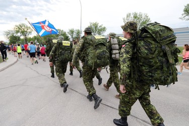 Members of the Cameron Highlanders of Canada participate in the men's half marathon at the 40th annual Manitoba Marathon in Winnipeg, Man., on Sunday, June 17, 2018. (Brook Jones/Postmedia Network)