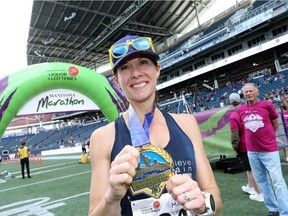 Elizabeth Forestell, originally from Niverville, Man., shows off her finisher medal after completing the women's full marathon at the 40th annual Manitoba Marathon in Winnipeg on Sunday.