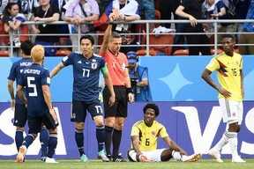 Slovenian referee Damir Skomina shows a red card to Colombia midfielder Carlos Sanchez during Tuesday's game. (GETTY IMAGES)