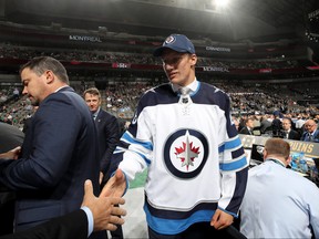 David Gustafsson reacts after being selected 60th overall by the Winnipeg Jets during the 2018 NHL Draft Saturday in Dallas,