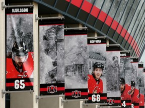Storm clouds gathered over Canadian Tire Centre in Ottawa on Wednesday, where images of teammates Erik Karlsson and Mike Hoffman hang together outside the arena. For now, that is.