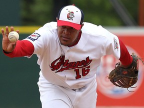 Winnipeg Goldeyes first baseman Reynaldo Rodriguez shows pitcher Kevin McGovern the ball to signal he will take the out himself during American Association baseball action against the Lincoln Saltdogs at Shaw Park in Winnipeg on May 31, 2018