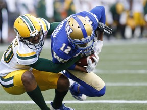 Blue Bombers' Adarius Bowman snags the touchdown pass against Edmonton Eskimos' Maurice McKnight during the first half of pre-season CFL action in Winnipeg Friday night. (THE CANADIAN PRESS)
