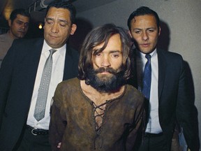 Charles Manson is escorted to his arraignment on conspiracy-murder charges in connection with the Sharon Tate murder case in 1969. (AP Photo)