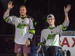 Humboldt Broncos bus crash survivors Kaleb Dahlgren, left, and Jacob Wasserman are introduced as the heroes of the game prior to the Saskatchewan Rush taking on the Rochester Knighthawks in game three of the the National Lacrosse League finals in Saskatoon on June 9, 2018. Ten of the 13 survivors from the Humboldt Broncos bus crash are in Las Vegas this week to attend the NHL awards. Some of the players who boarded flights in Saskatoon Monday said it will be emotional, but great to see their former teammates.