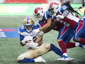 Winnipeg Blue Bombers' Andrew Harris (left) goes in for a touchdown during first half CFL football action against the Montreal Alouettes in Montreal, Friday. Harris was one of three Winnipeg products to score touchdowns Friday.