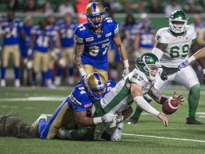 Winnipeg Blue Bombers defensive end Jackson Jeffcoat (94) tackles Saskatchewan Roughriders quarterback Bryan Bennett (17) during second half CFL football action in Regina on Saturday, June 10, 2017. THE CANADIAN PRESS/Rick Elvin ORG XMIT: RRE112 ORG XMIT: POS1706102341479601 ORG XMIT: POS1706141805008324