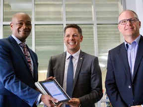 (Left to right) Shaw Communitions VP of government relations Chima Nkemdirim, Mayor Brian Bowman and Coun. Scott Gillingham (St. James-Brooklands-Weston) show off the city's partnership with Shaw that will see free Wi-Fi access in town at more than 130 public places.