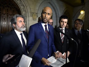 Minister of Immigration, Refugees and Citizenship Ahmed Hussen speaks to reporters, as Chief Government Whip Pablo Rodiguez, right, looks on, following Question Period in the House of Commons on Parliament Hill in Ottawa on Friday, June 1, 2018.