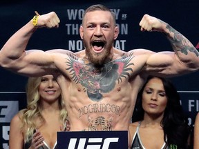 In this Nov. 11, 2016, file photo, Conor McGregor stands on a scale during the weigh-in event for his fight against Eddie Alvarez in UFC 205 mixed martial arts at Madison Square Garden in New York.