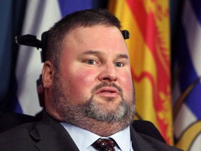 Conservative MP Steven Fletcher holds a press conference on Parliament Hill, in Ottawa Thursday March 27, 2014. A Manitoba politician is apologizing for saying a crash that left Fletcher a quadriplegic was a gift.