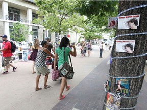 People walk through Old Market Square during the 2015 Winnipeg Fringe Festival.