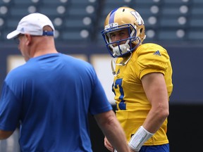 Chris Streveler (right) checks in with offensive co-ordinator Paul LaPolice during Blue Bombers practice. (Kevin King/Winnipeg Sun)