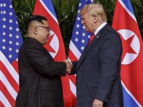 U.S. President Donald Trump shakes hands with North Korea leader Kim Jong Un at the Capella resort on Sentosa Island Tuesday, June 12, 2018 in Singapore.