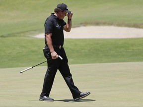 Phil Mickelson tips his cap after finishing the final round of the U.S. Open Golf Championship, Sunday, June 17, 2018, in Southampton, N.Y. (AP Photo/Frank Franklin II)