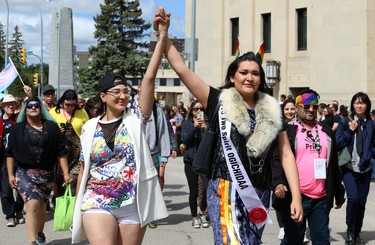 Parade marshall Brielle Beardy-Linklater (right) marches with another person during the Pride Day parade on York Avenue in Winnipeg on Sun., June 3, 2018. Kevin King/Winnipeg Sun/Postmedia Network