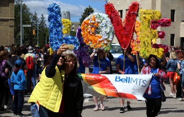 People take a selfie in front of the Bell MTS float during the Pride Day parade on York Avenue in Winnipeg on Sun., June 3, 2018. Kevin King/Winnipeg Sun/Postmedia Network