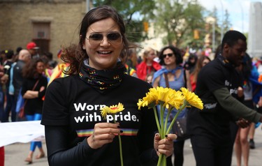 Flowers are handed out during the Pride Day parade on York Avenue in Winnipeg on Sun., June 3, 2018. Kevin King/Winnipeg Sun/Postmedia Network