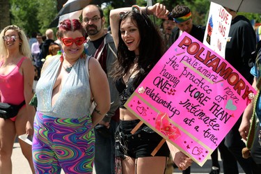 A woman spells it out during the Pride Day parade on York Avenue in Winnipeg on Sun., June 3, 2018. Kevin King/Winnipeg Sun/Postmedia Network