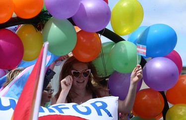 A woman is framed by balloons during the Pride Day parade on York Avenue in Winnipeg on Sun., June 3, 2018. Kevin King/Winnipeg Sun/Postmedia Network