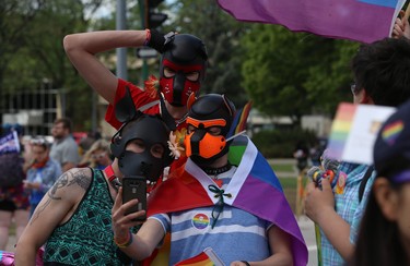 Three people in masks pose at the end of the Pride Day parade on York Avenue in Winnipeg on Sun., June 3, 2018. Kevin King/Winnipeg Sun/Postmedia Network