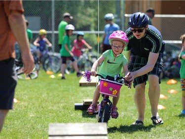 Todd White helps his daughter on the obstacle course at Mulvey School during the Fam Jam Wheel Jam in Winnipeg on Sun., June 10, 2018. Kevin King/Winnipeg Sun/Postmedia Network