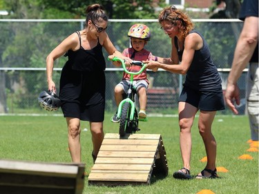 Renee Hill (left) helps son Charlie, 4, on the obstacle course at Mulvey School during the Fam Jam Wheel Jam in Winnipeg on Sun., June 10, 2018. Kevin King/Winnipeg Sun/Postmedia Network